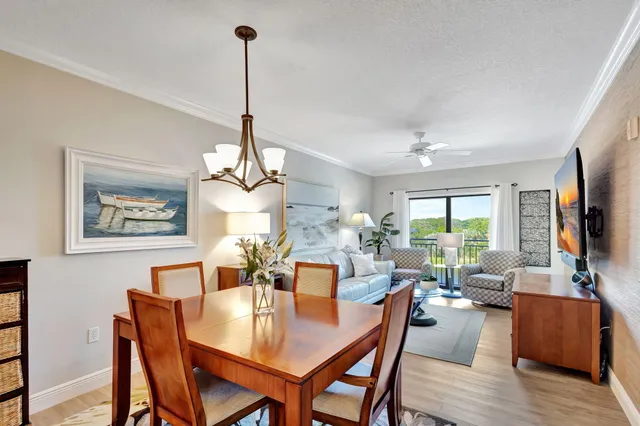 a view of a dining room with furniture wooden floor and a chandelier