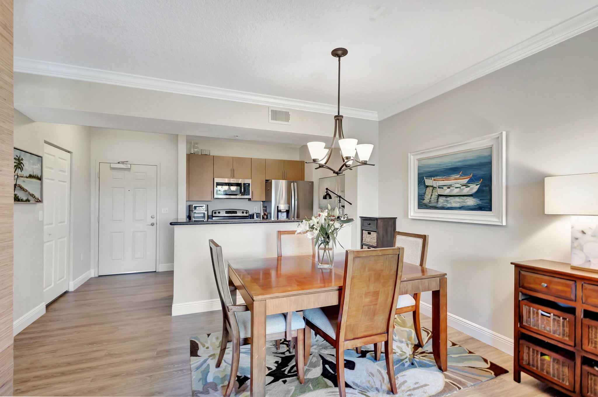4903 Midtown Lane, Unit 3313 Palm Beach Gardens, FL 33418 - Photo 10 of 81 a view of a dining room with furniture wooden floor and a chandelier