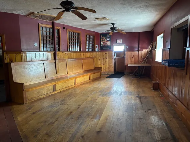 a view of a room with an empty space and wooden floor
