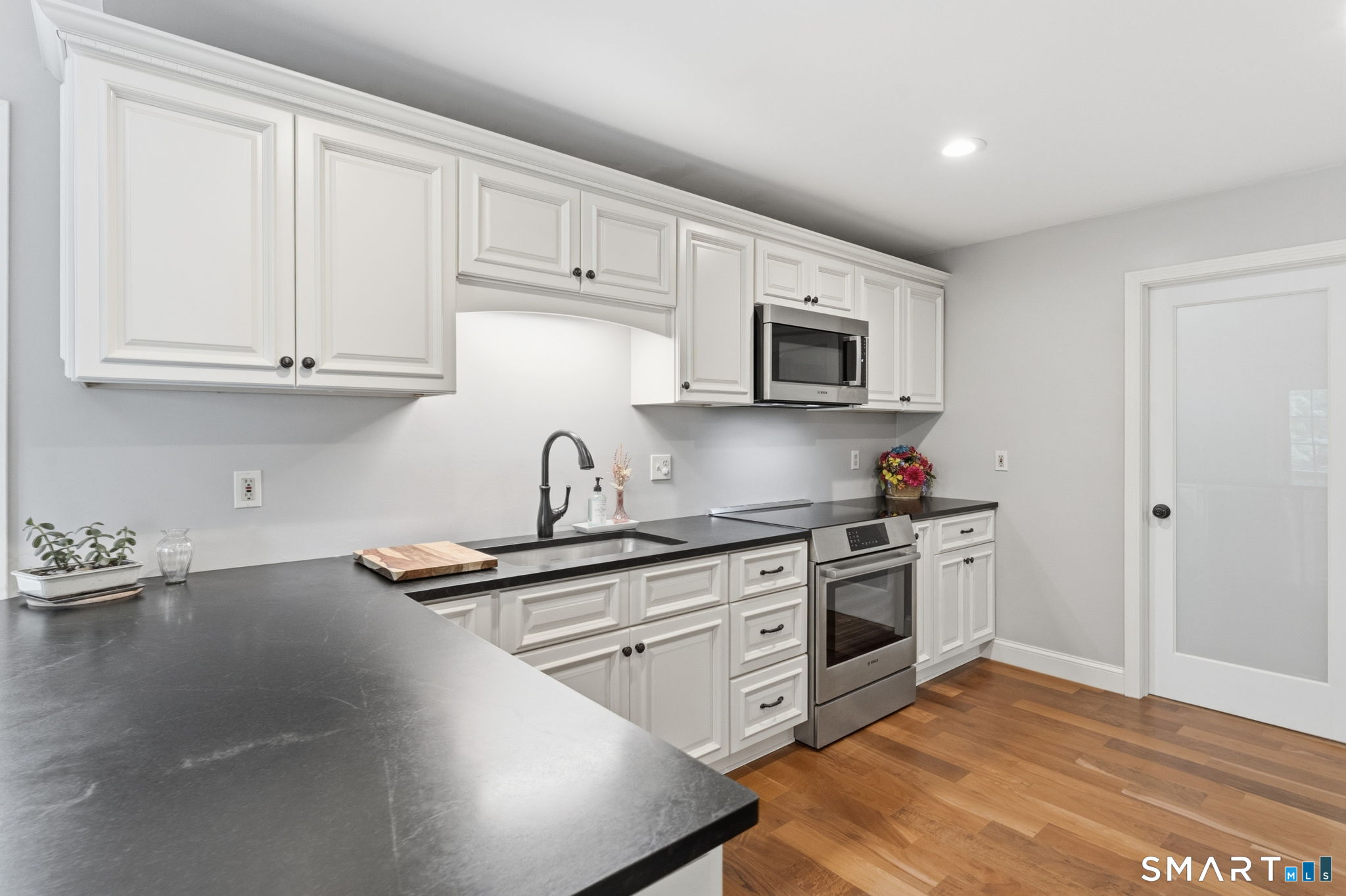 287 South Bear Hill Road Chaplin, CT 06235 - Photo 13 of 37 a kitchen with stainless steel appliances granite countertop a stove a sink dishwasher and a microwave oven with wooden cabinets