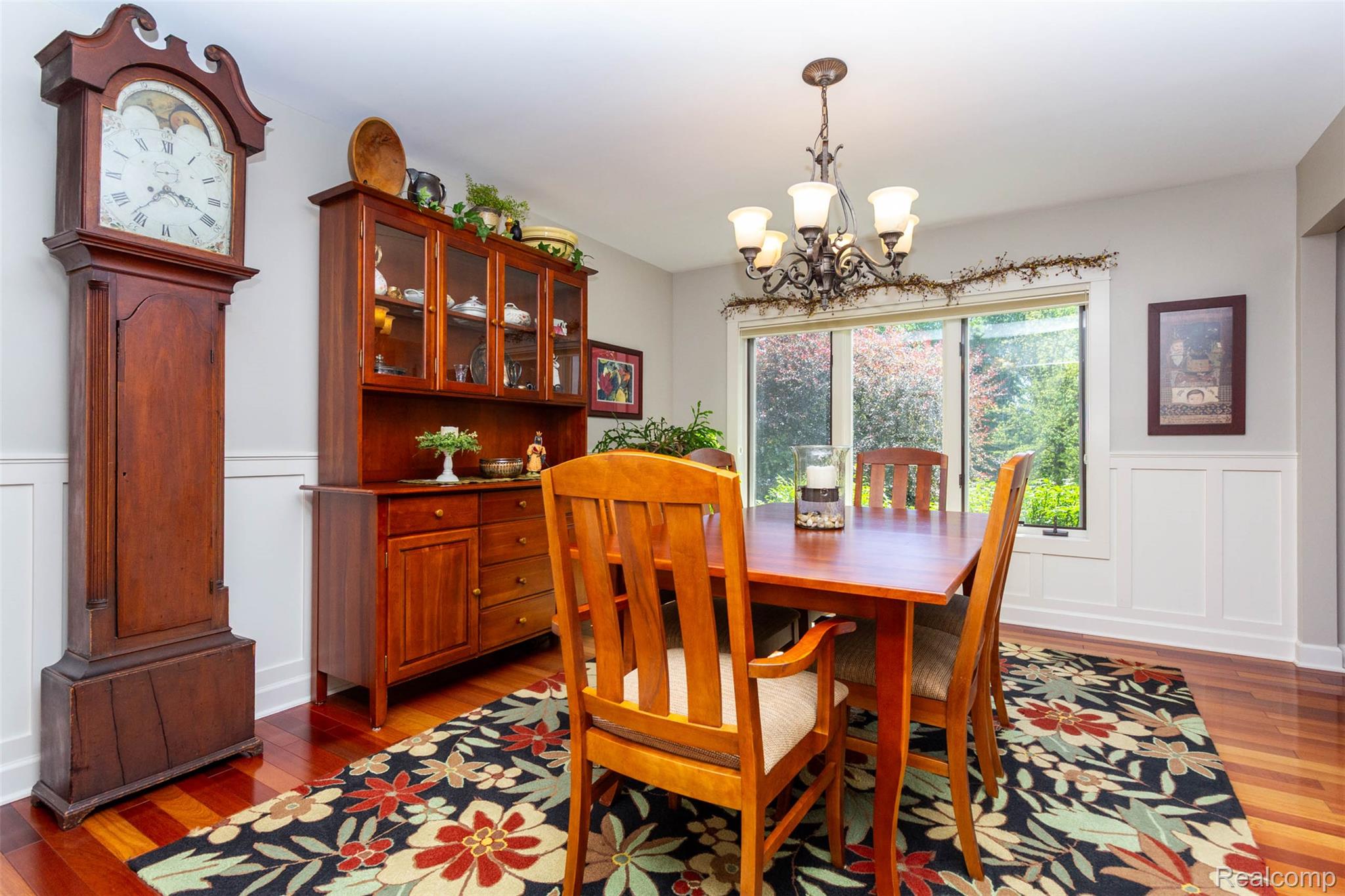 9887 Hadley Road Clarkston, MI 48348 - Photo 15 of 56 Dining area featuring cherry wood-finish flooring and white wainscoting