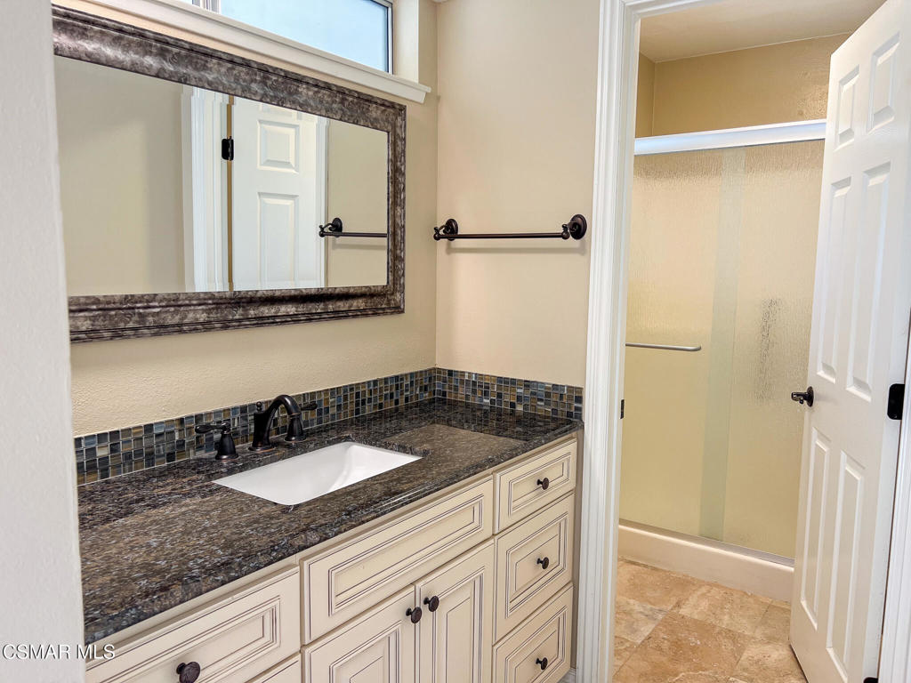 5458 Softwind Way Agoura Hills, CA 91301 - Photo 19 of 31 a bathroom with a granite countertop sink and a mirror