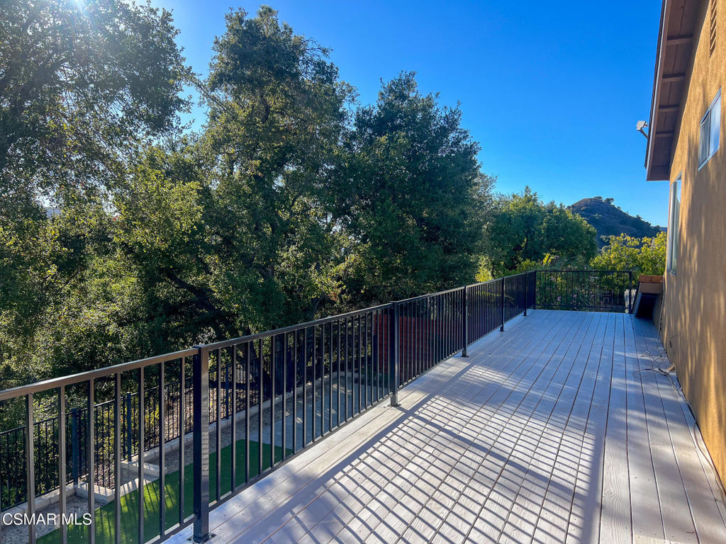 5458 Softwind Way Agoura Hills, CA 91301 - Photo 22 of 31 a view of balcony with wooden floor and fence