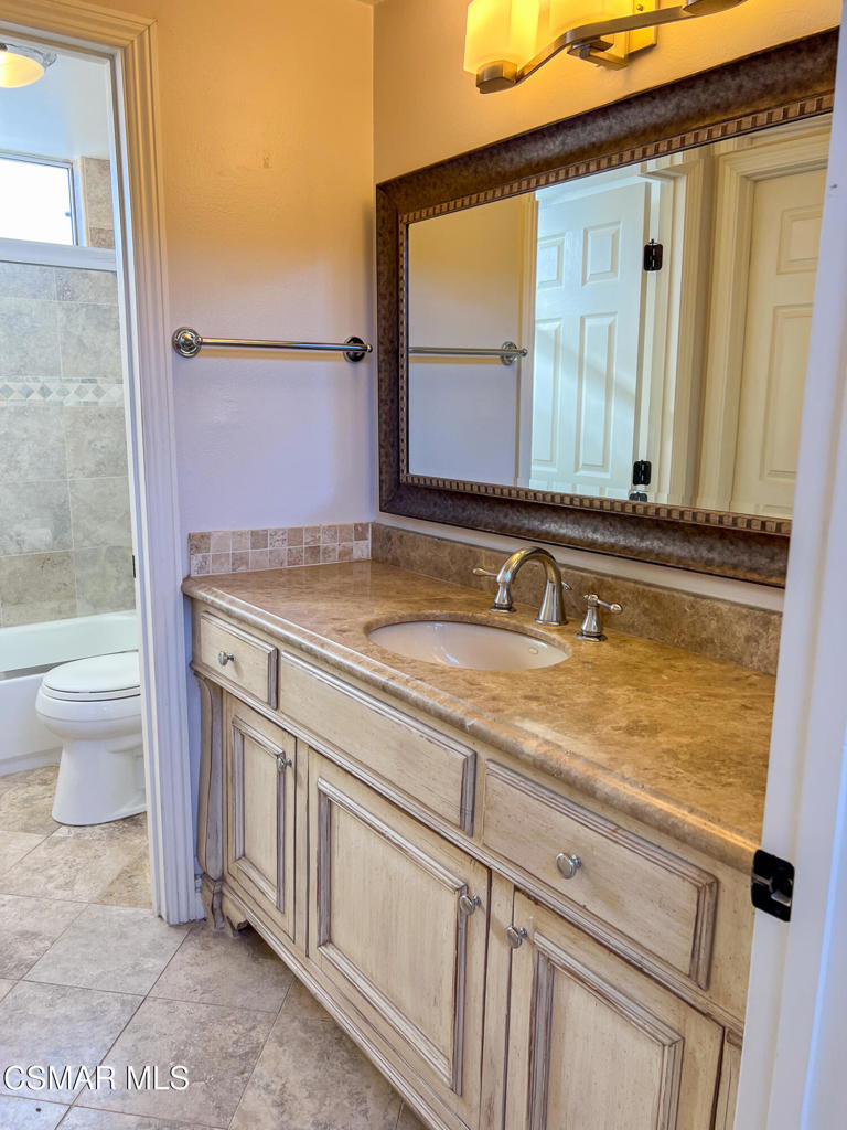 5458 Softwind Way Agoura Hills, CA 91301 - Photo 27 of 31 a bathroom with a sink and a toilet