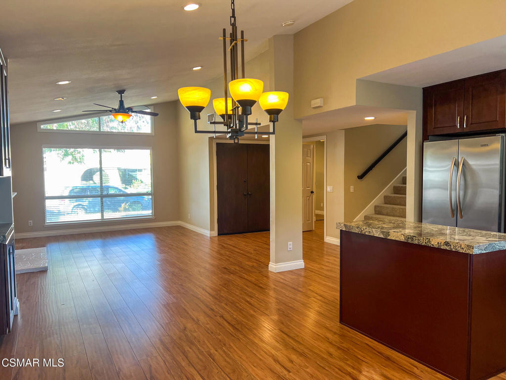 5458 Softwind Way Agoura Hills, CA 91301 - Photo 6 of 31 a kitchen with stainless steel appliances granite countertop a refrigerator a stove top oven and a wooden floors
