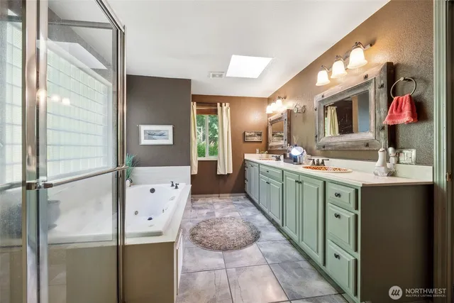 a bathroom with a double vanity sink mirror and shower