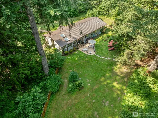 an aerial view of a house with a yard