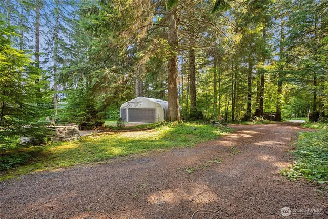 a backyard of a house with a yard and outdoor seating