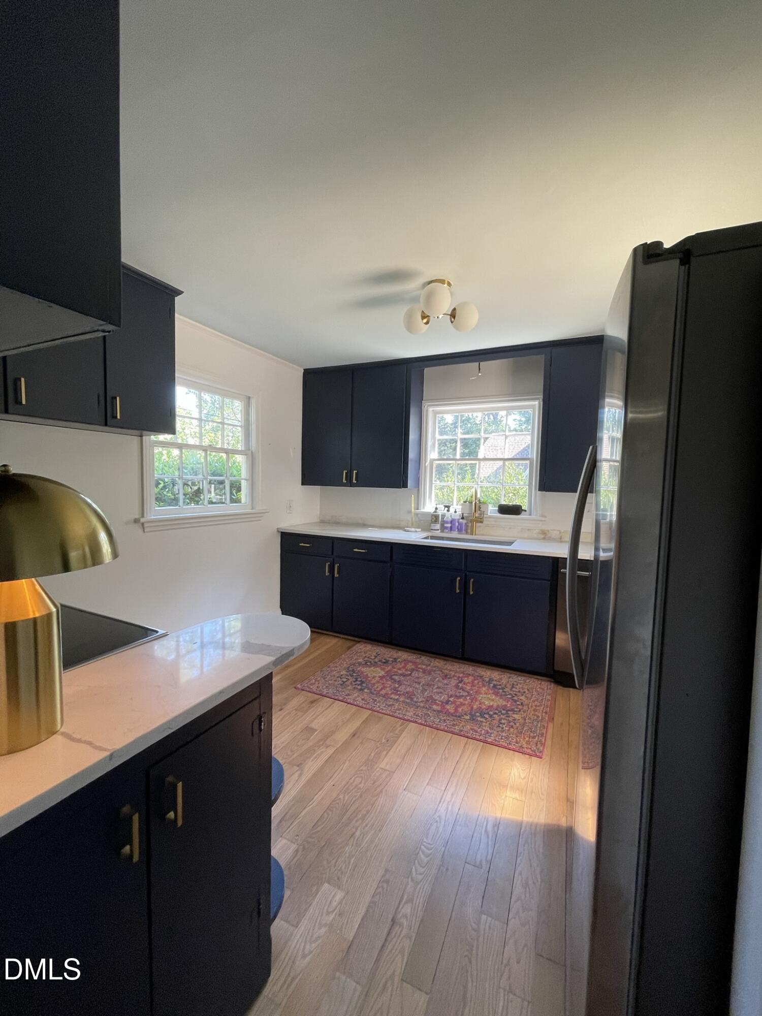 1009 Canterbury Road Raleigh, NC 27607 - Photo 27 of 31 a kitchen with kitchen island sink and refrigerator