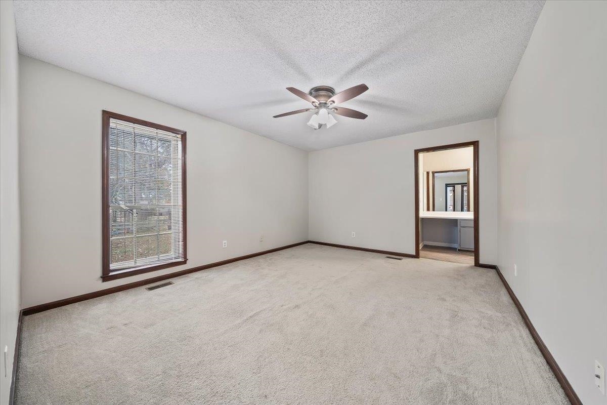 10060 Rosemark Road Atoka, TN 38004 - Photo 14 of 26 an empty room with windows and ceiling fan