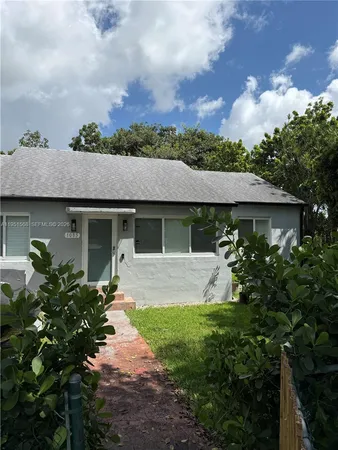 a front view of a house with a garden and porch