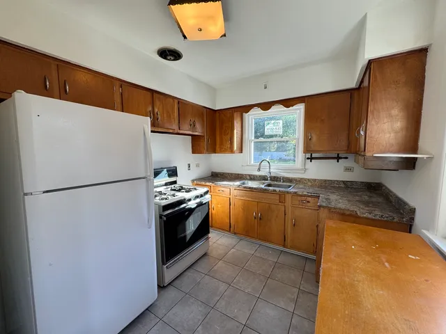 a white refrigerator freezer sitting inside of a kitchen