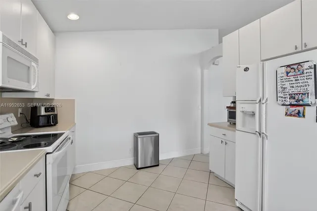 a kitchen with cabinets and a stove top oven
