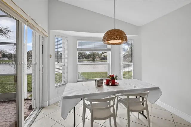 a dining room with furniture and window