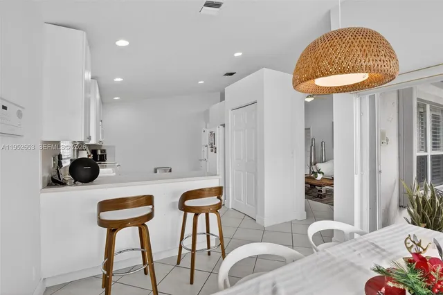 a kitchen with stainless steel appliances granite countertop a table and chairs