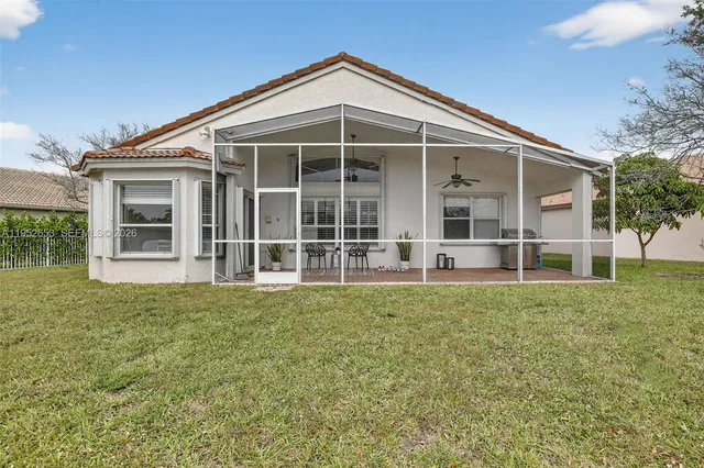 a view of a house with backyard and porch