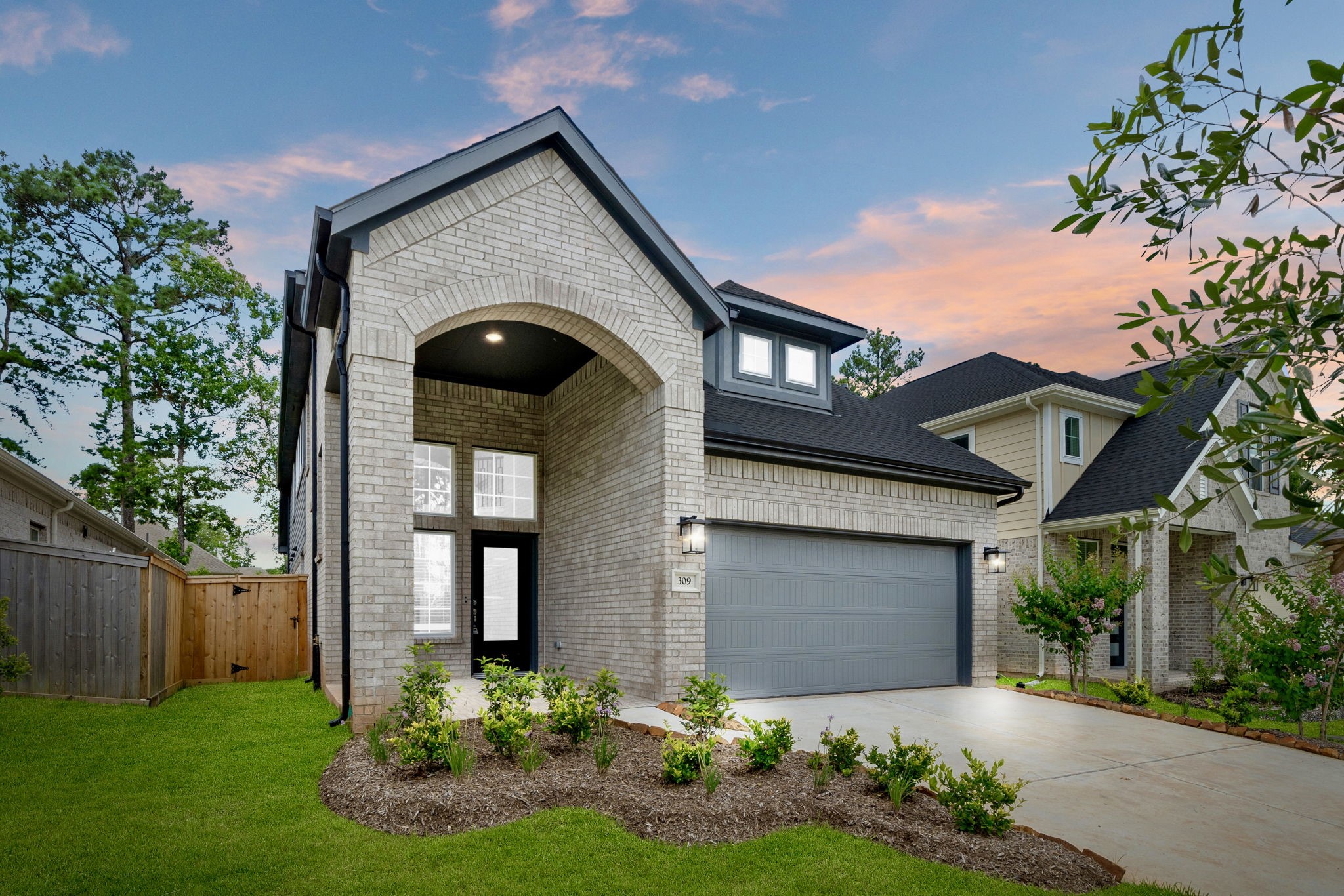 12846 Meadow Wind Way Conroe, TX 77302 - Photo 1 of 32 a front view of a house with a yard and porch
