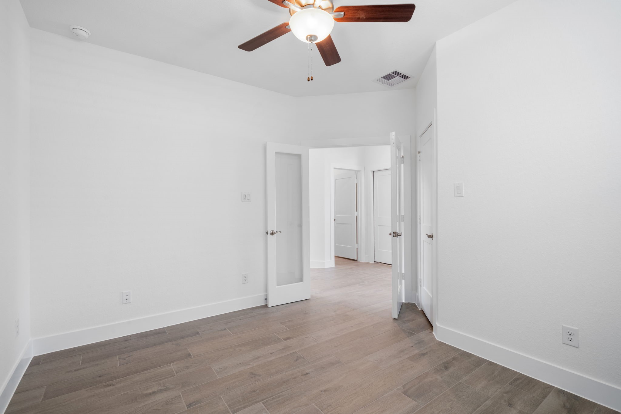 12846 Meadow Wind Way Conroe, TX 77302 - Photo 11 of 32 a view of a room with wooden floor