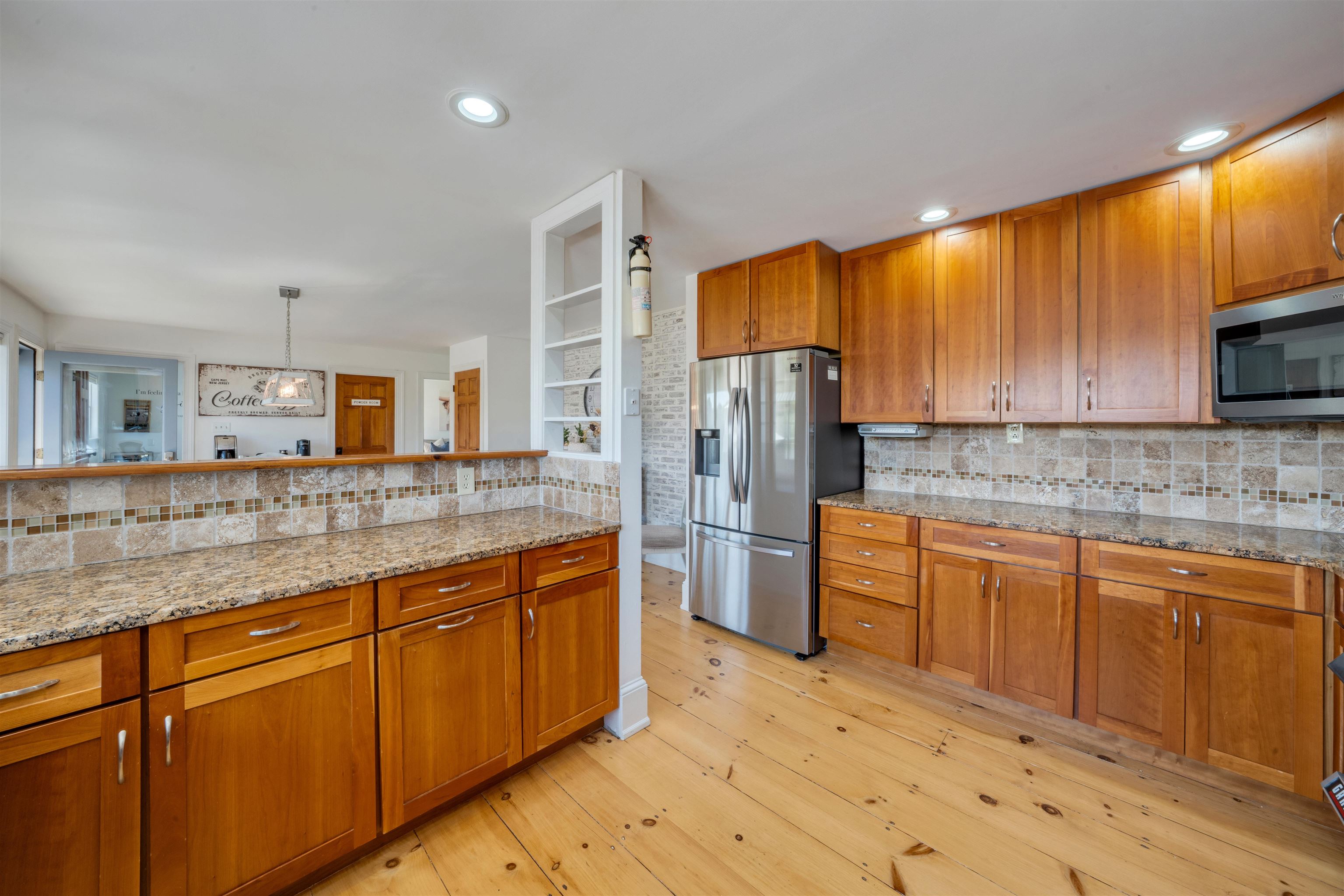 892 Weeks Landing Road Erma, NJ 08204 - Photo 12 of 50 a kitchen with stainless steel appliances granite countertop a refrigerator sink and cabinets