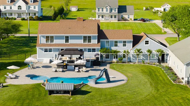 a aerial view of a house with swimming pool and patio