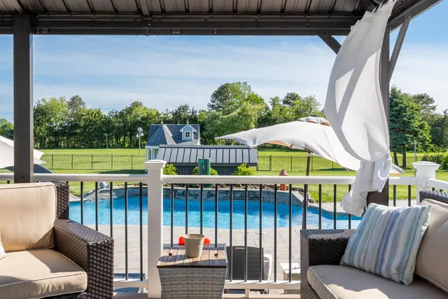 a swimming pool with outdoor seating and yard