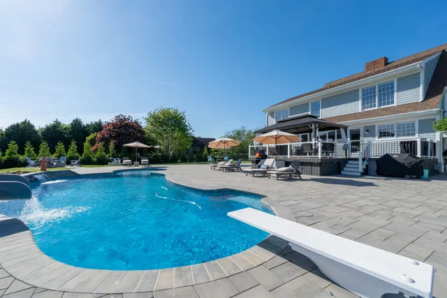 a view of a swimming pool with an outdoor seating