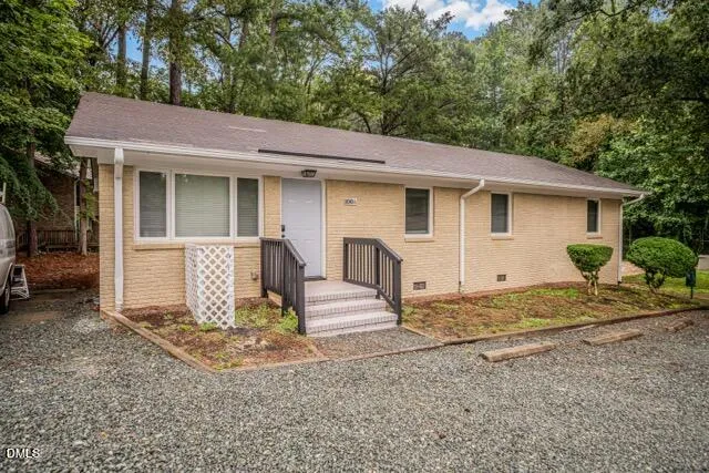 a view of a house with a patio and backyard