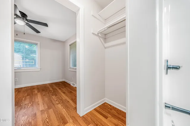 a view of room with window and wooden floor