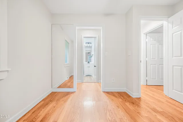 a view of a room with wooden floor and bathroom