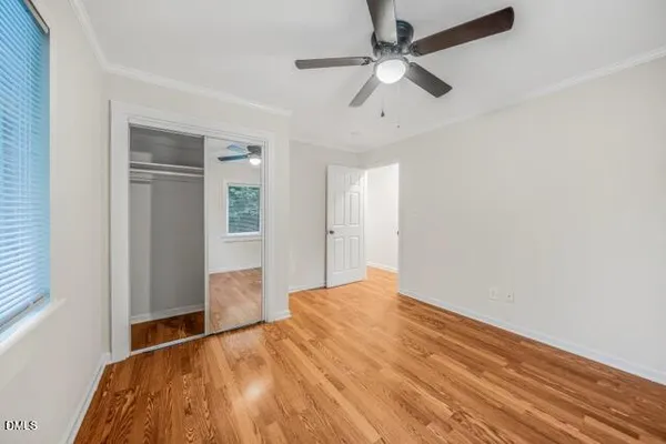 a view of empty room with wooden floor