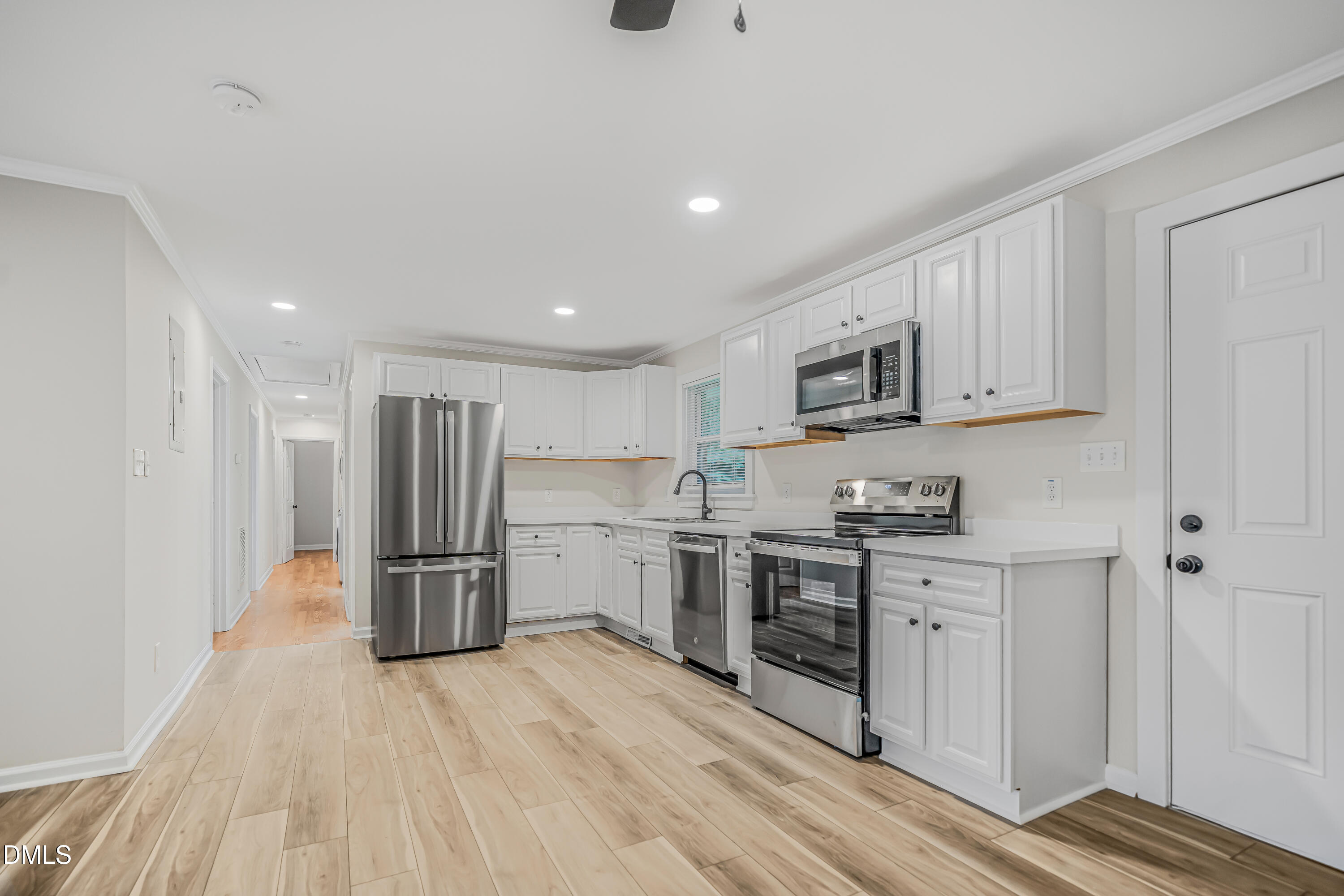 201 Howell Street, Unit 100A Chapel Hill, NC 27514 - Photo 3 of 22 a kitchen with stainless steel appliances granite countertop a refrigerator and a stove top oven