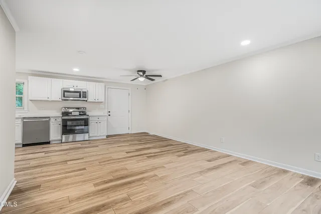 a view of kitchen with microwave and cabinets