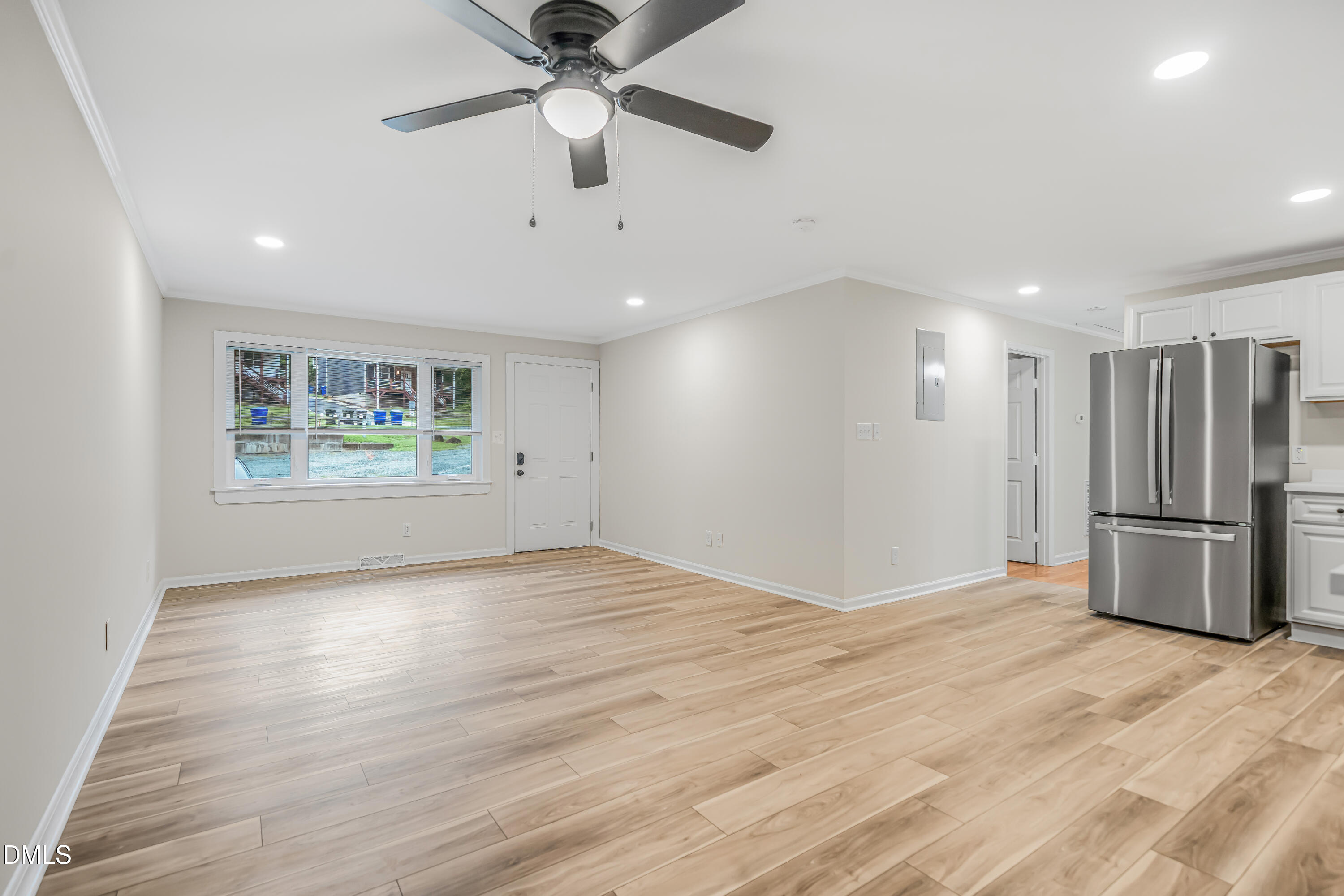 201 Howell Street, Unit 100A Chapel Hill, NC 27514 - Photo 6 of 22 a view of an empty room with a window and kitchen view