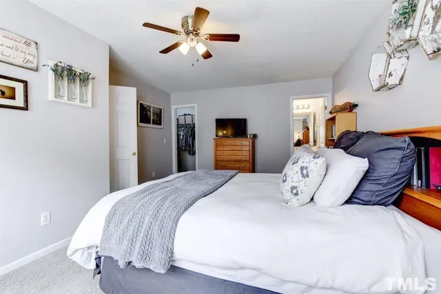 a bedroom with bed and a chandelier
