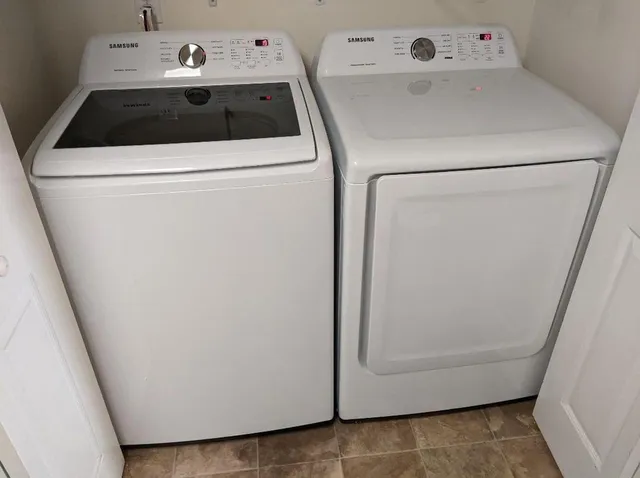 a view of a chair and table in the backyard