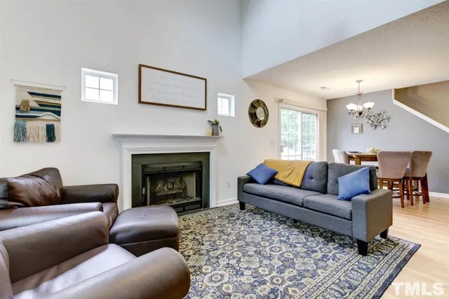 a kitchen with stainless steel appliances couches dining table and chairs