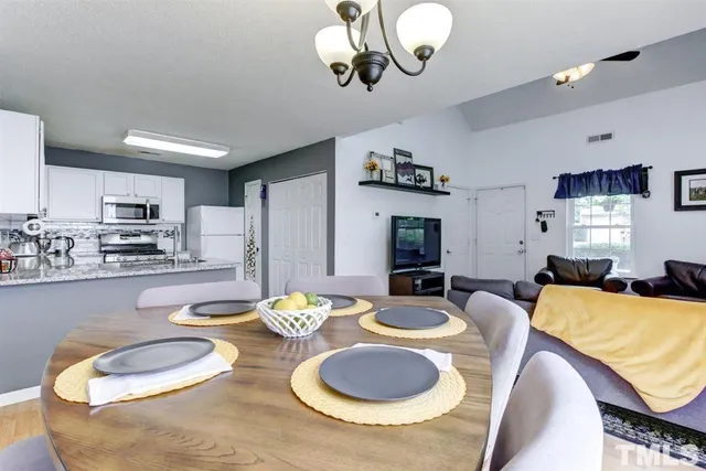a living room with furniture and kitchen view