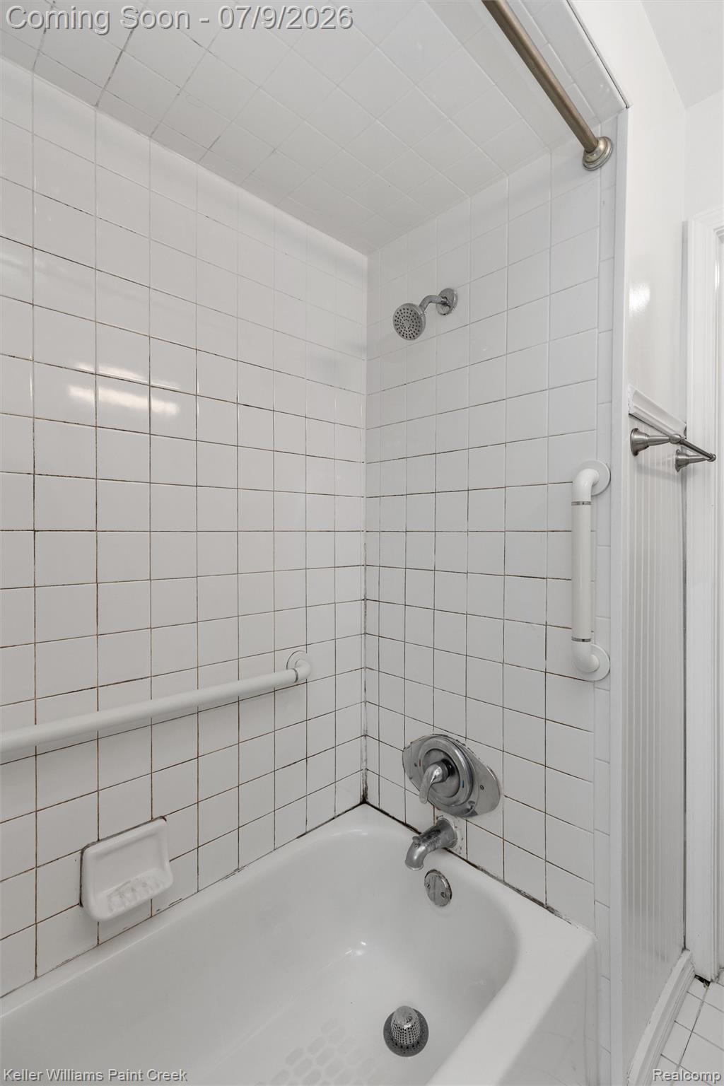 2731 Crooks Road Royal Oak, MI 48073 - Photo 5 of 34 White subway tile surround with integrated bathtub and shower fixtures