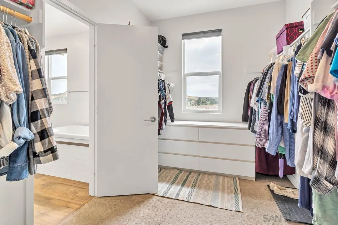 8869 Trailridge Avenue Santee, CA 92071 - Photo 22 of 48 a view of walk in closet with clothes and shoes