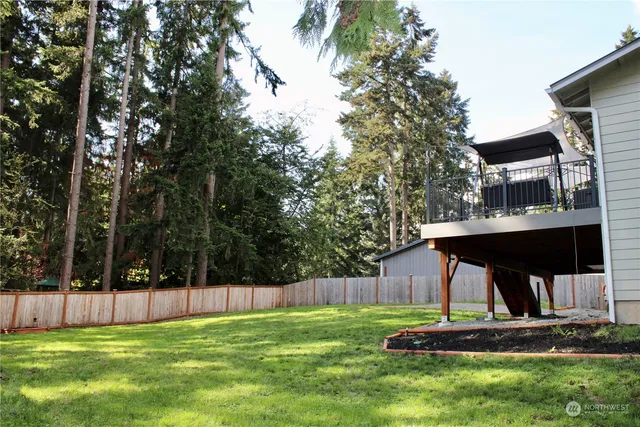 a view of house with backyard