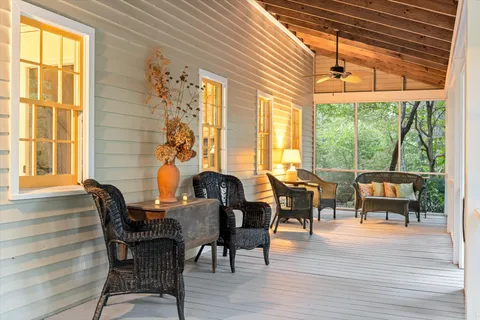 a living room with a table chairs and a wooden floor
