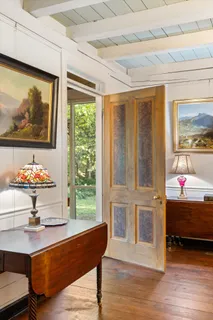 a view of a dining room with furniture and windows