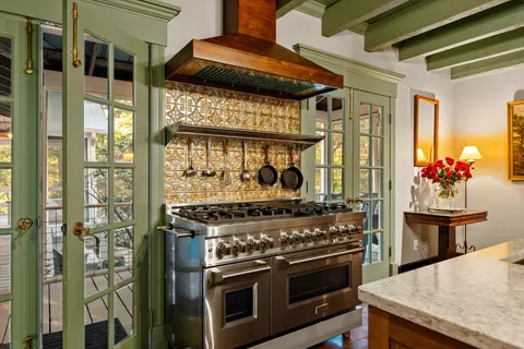 a dining room with furniture and a floor to ceiling window