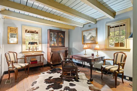 a living room with a couch next to a large window