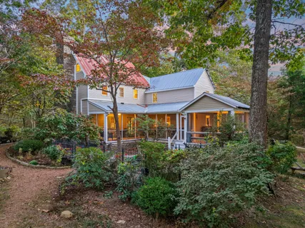 front view of a house with a large trees