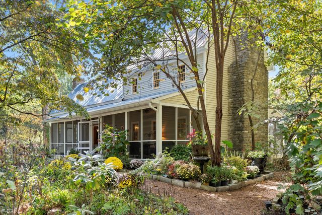 a backyard of a house with lots of green space and fountain