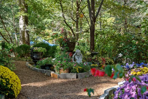 a living room with furniture a rug and a chandelier