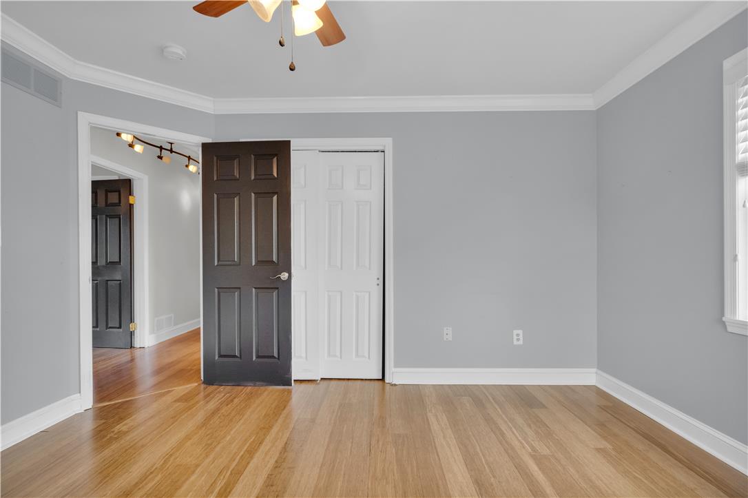 3396 Darien Road Bethlehem, PA 18020 - Photo 28 of 44 Hardwood floors and track lighting illuminate this comfortable bedroom, featuring crown molding and a ceiling fan for year-round comfort.