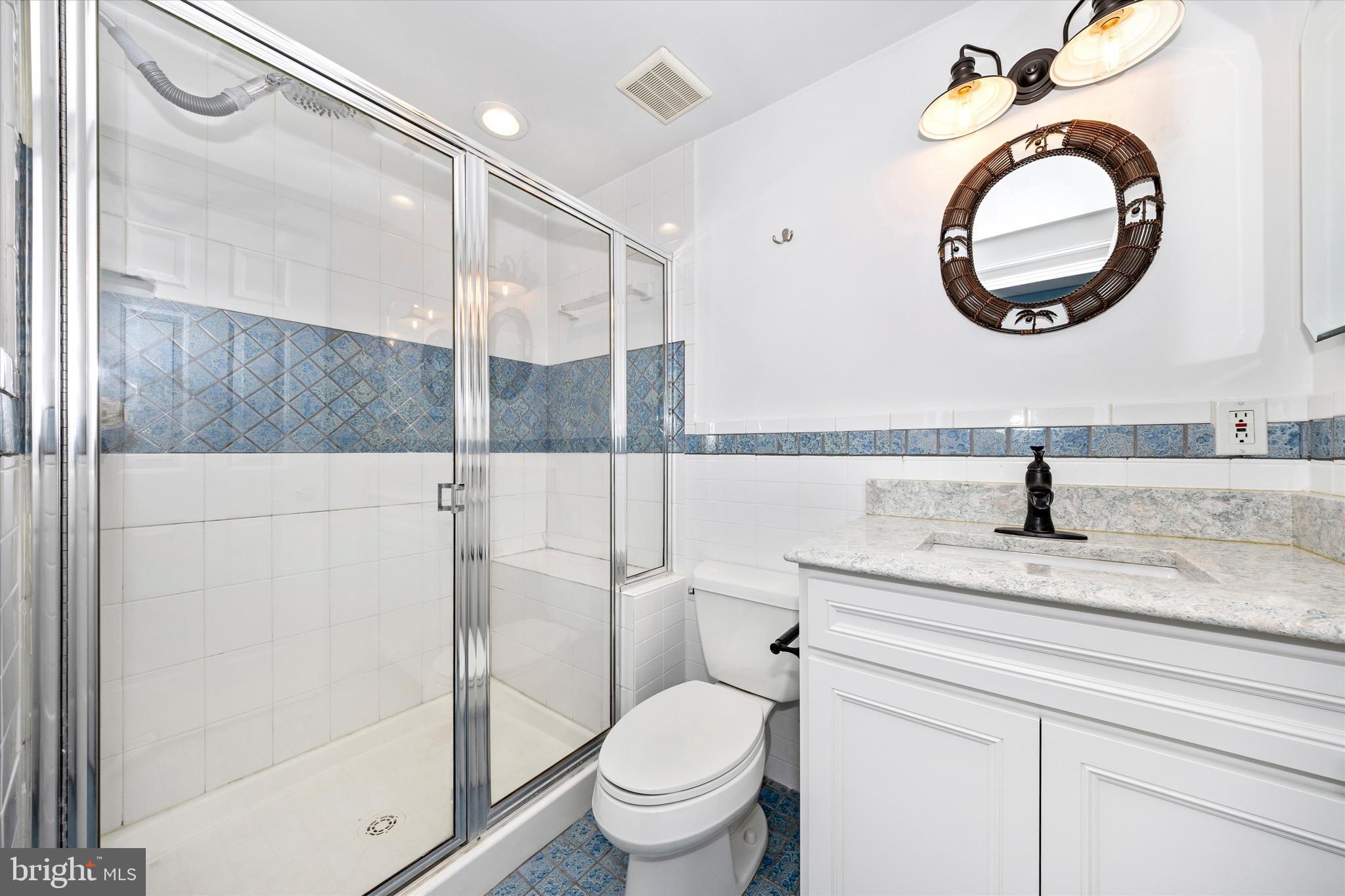 803 Apache Court Frederick, MD 21701 - Photo 33 of 46 a bathroom with a granite countertop toilet sink and mirror