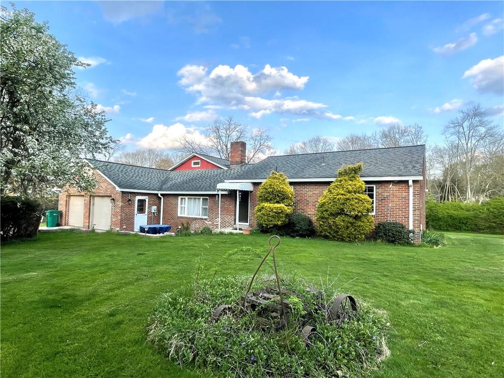 a view of a house with a big yard and large trees